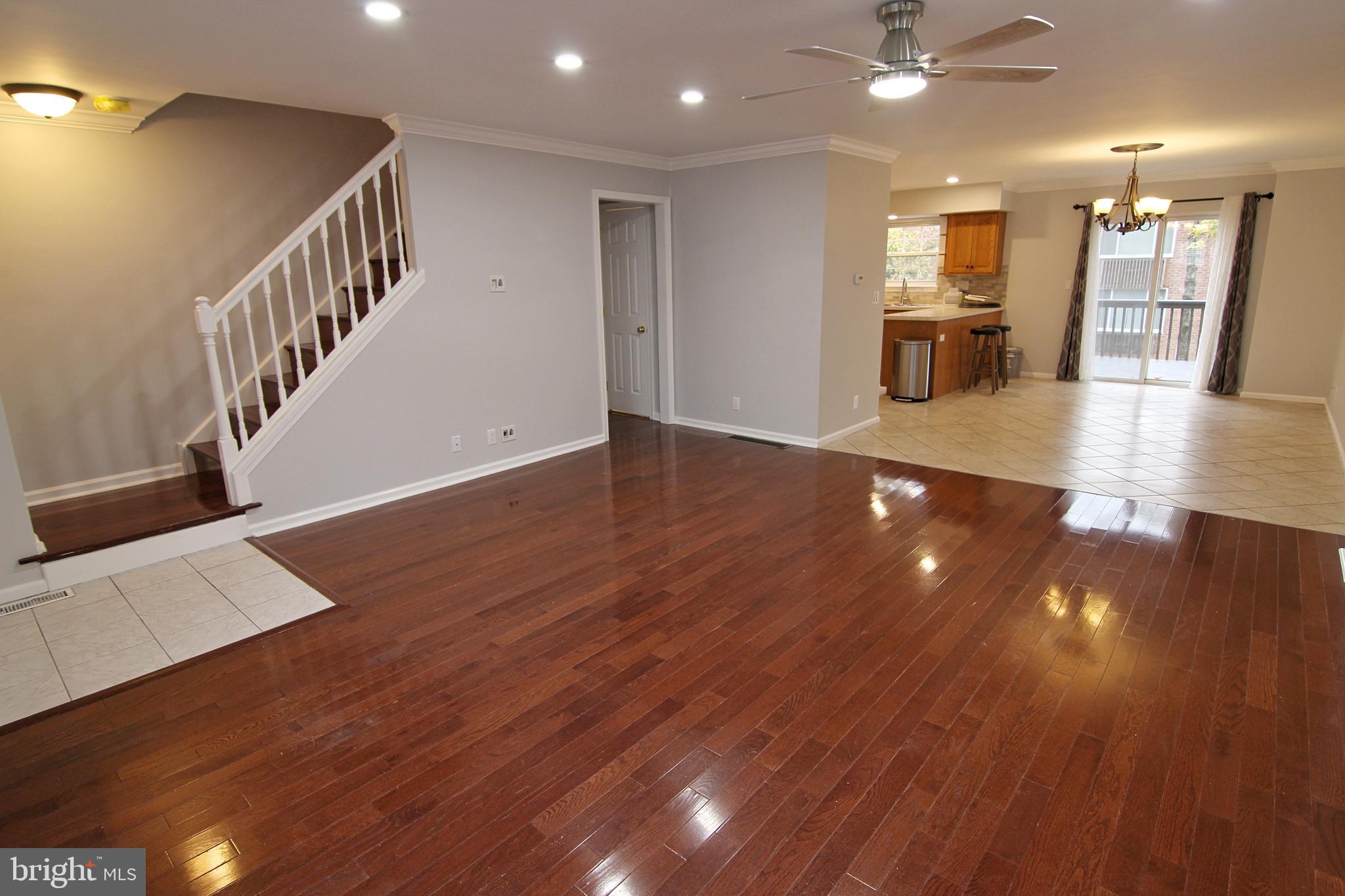 7923-31 Ridge Avenue, Unit 38 Philadelphia, PA 19128 - Photo 3 of 23 a view of a hallway with wooden floor and staircase