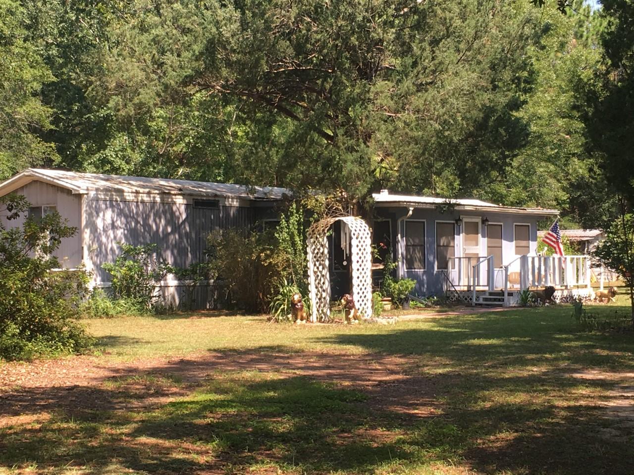 967 Lighthouse Church Road Holt, FL 32564 - Photo 1 of 2 a front view of a house with a yard