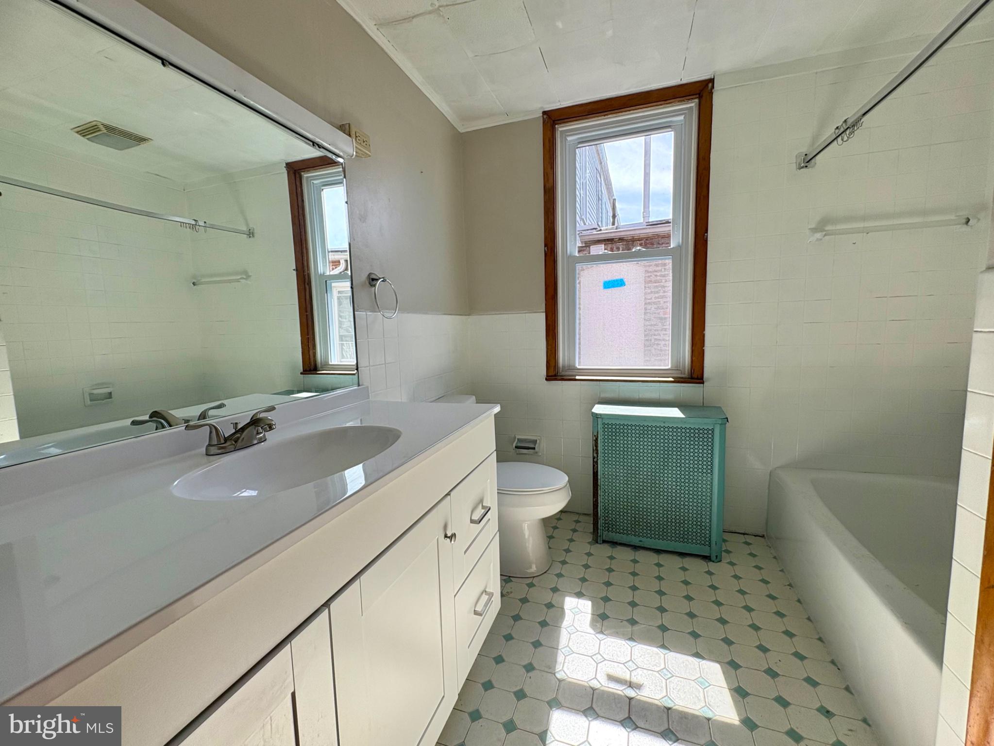 257 West Jackson Street York, PA 17401 - Photo 17 of 27 a bathroom with a sink a toilet and mirror