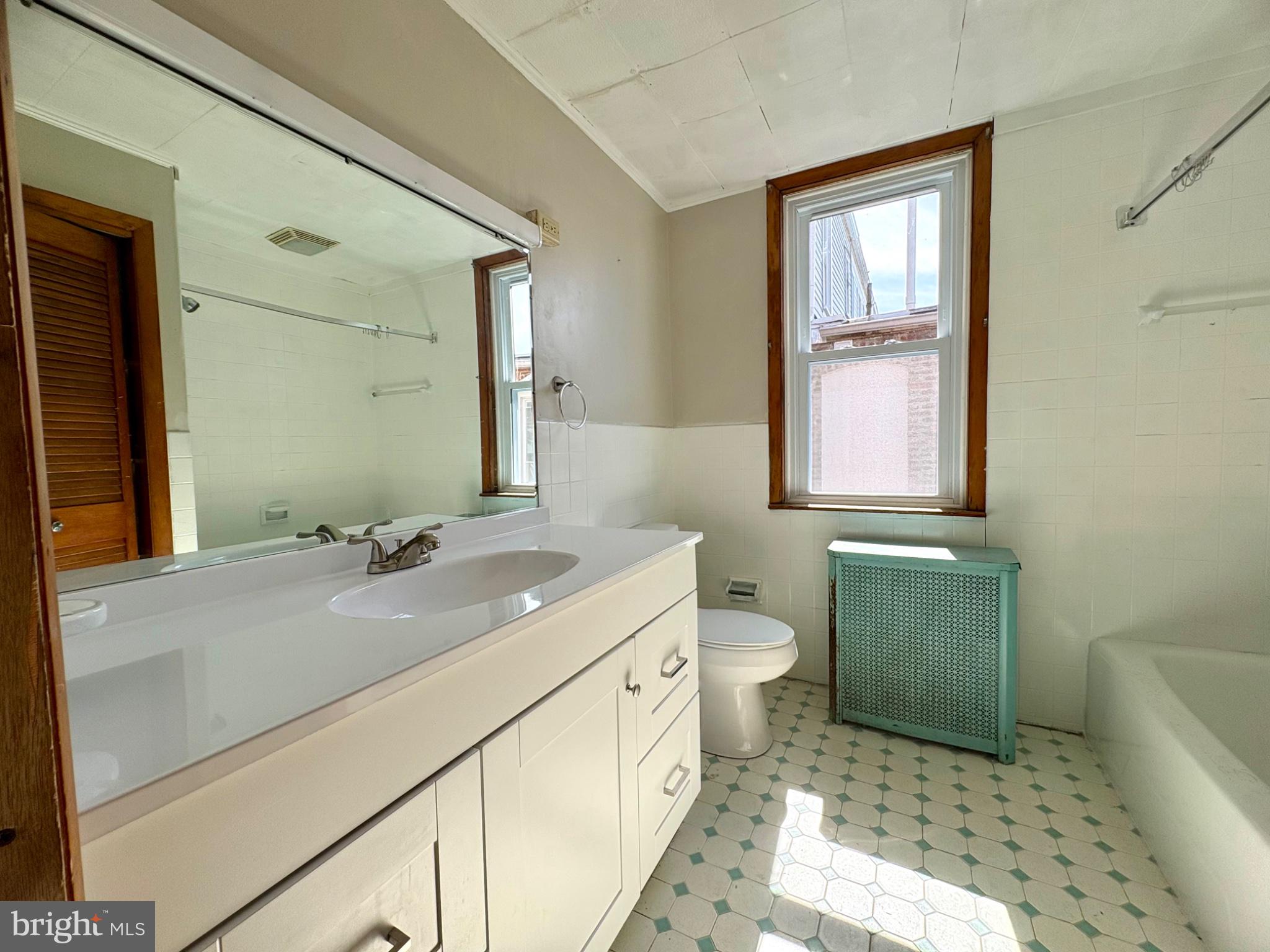 257 West Jackson Street York, PA 17401 - Photo 18 of 27 a bathroom with a sink a toilet and mirror