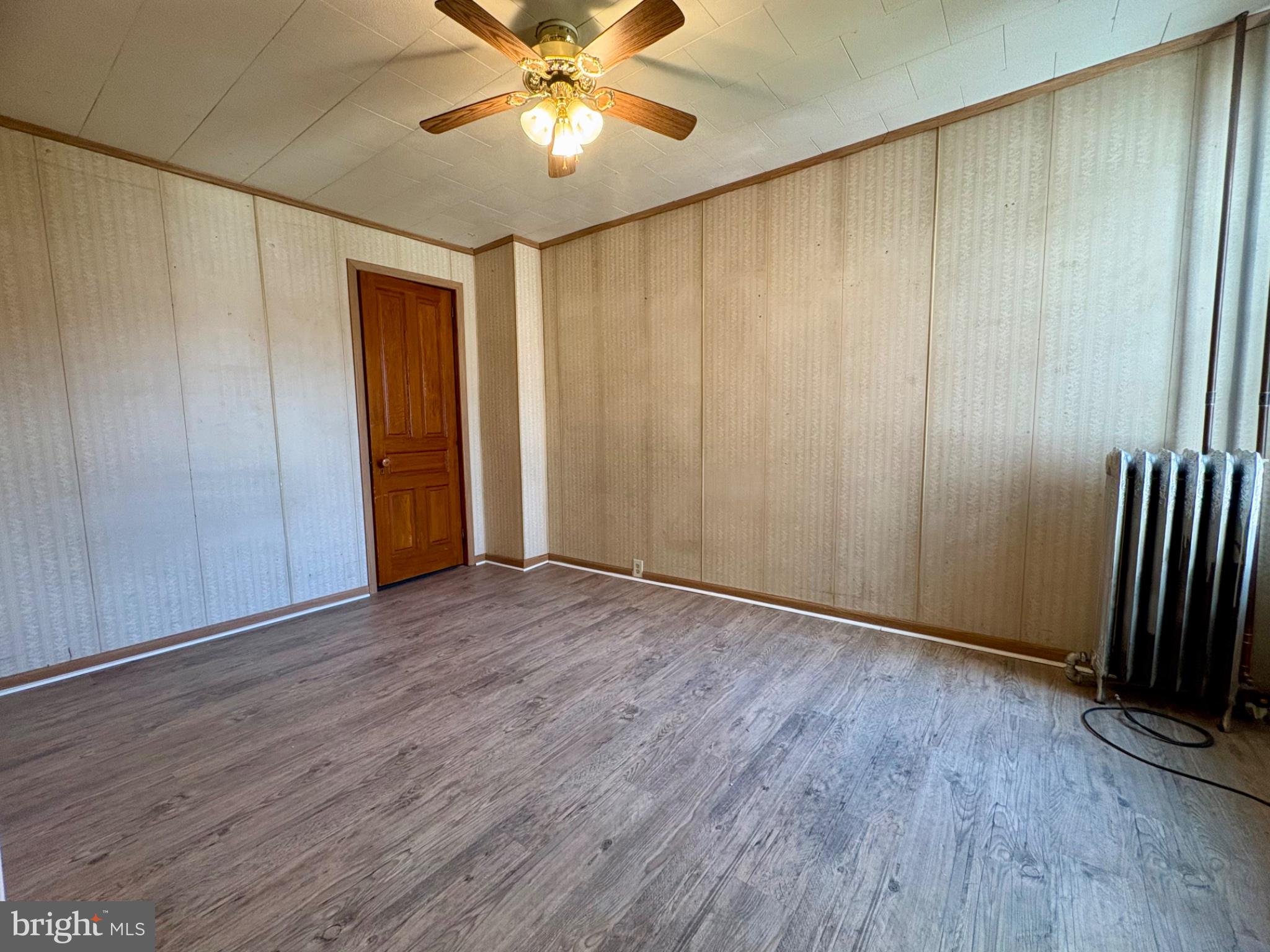 257 West Jackson Street York, PA 17401 - Photo 19 of 27 an empty room with wooden floor closet fan and windows
