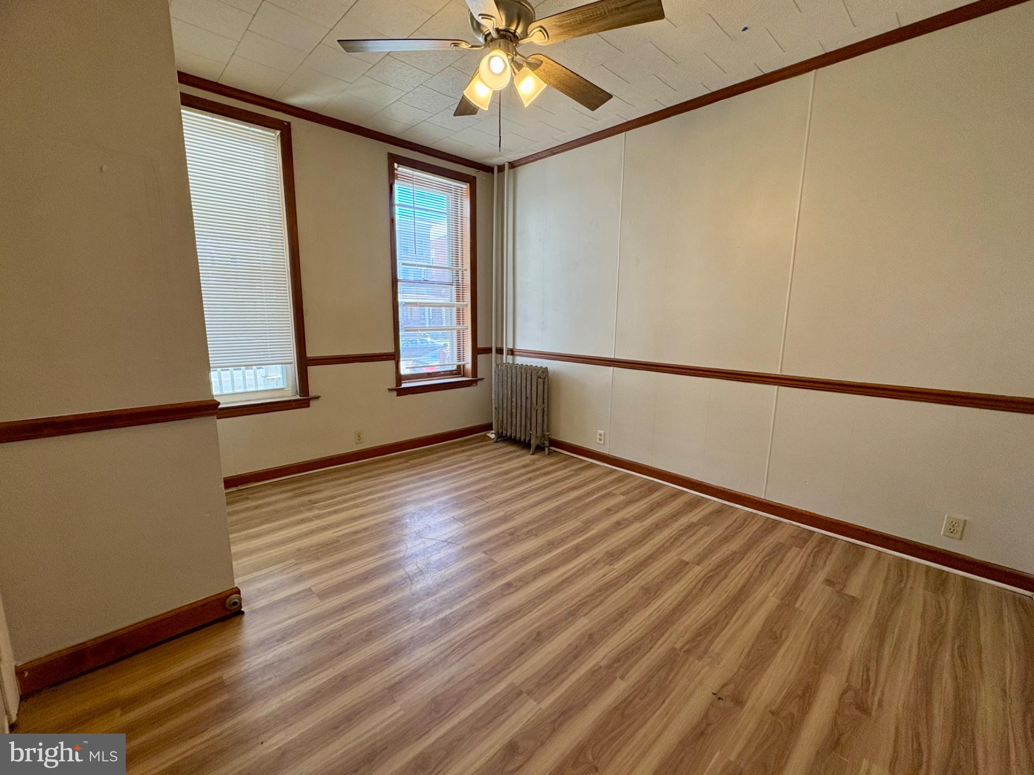 257 West Jackson Street York, PA 17401 - Photo 4 of 27 a view of an empty room with wooden floor and a window