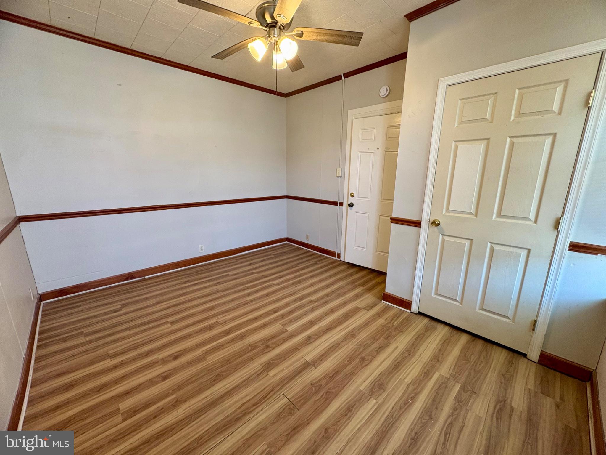 257 West Jackson Street York, PA 17401 - Photo 5 of 27 a view of an empty room with wooden floor and a ceiling fan