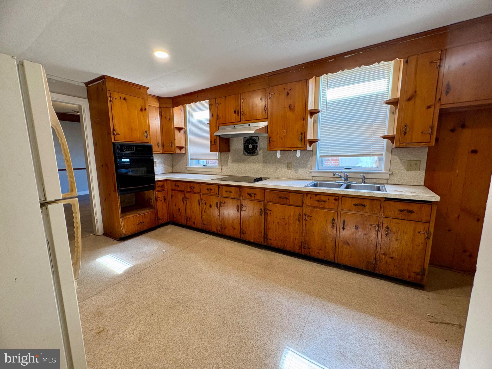 257 West Jackson Street York, PA 17401 - Photo 9 of 27 a kitchen with stainless steel appliances granite countertop a refrigerator a sink and wooden cabinets