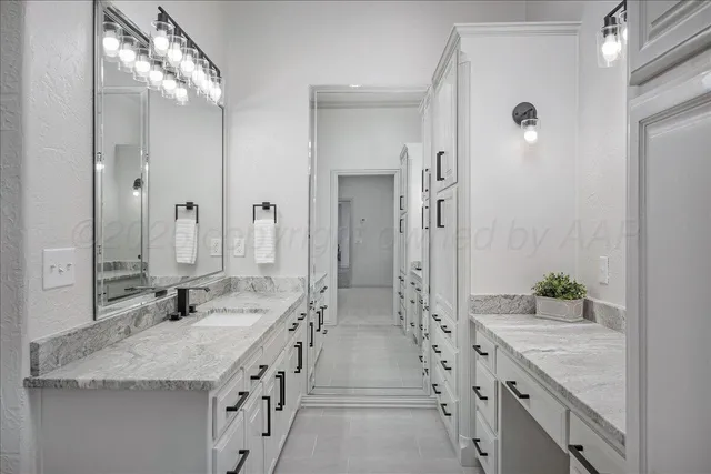 a bathroom with a sink a vanity and a mirror