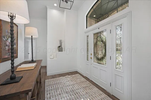 an empty room with a ceiling fan and windows