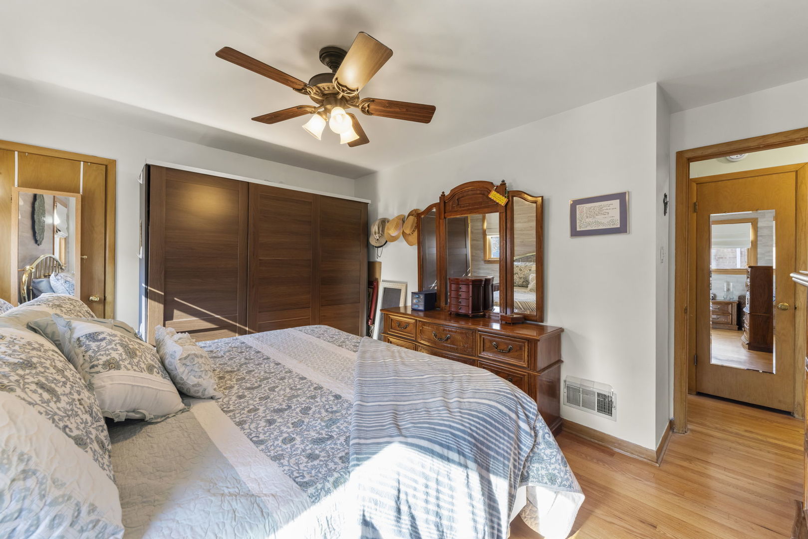 8625 South Kildare Avenue Chicago, IL 60652 - Photo 11 of 26 a bedroom with a large bed a flat tv screen and dresser