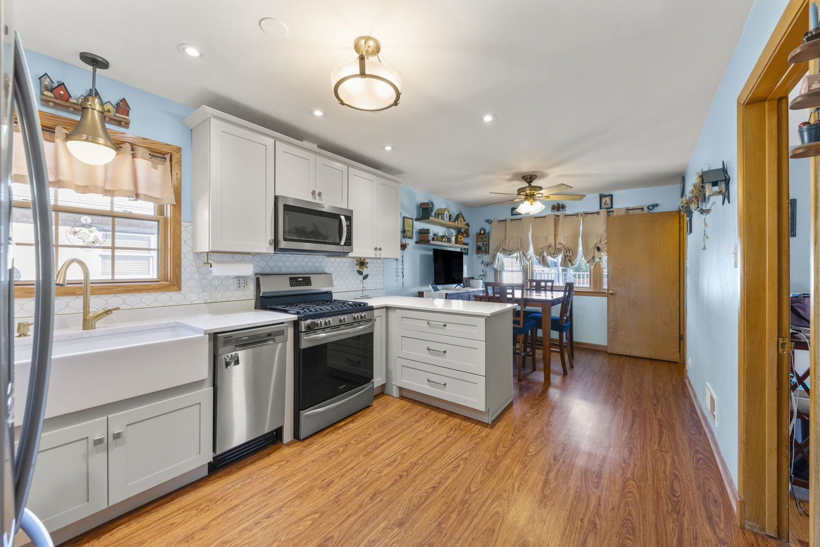 8625 South Kildare Avenue Chicago, IL 60652 - Photo 6 of 26 a kitchen with a wooden floor stove top oven and refrigerator