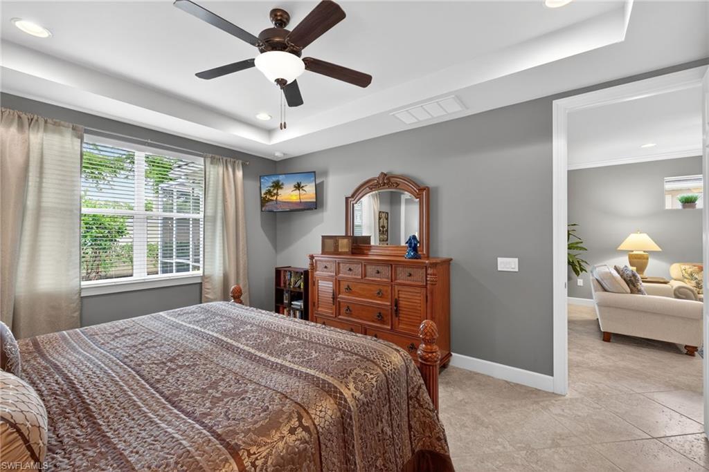 20105 Torch Key Way Estero, FL 33928 - Photo 14 of 29 a bedroom with a bed and a chandelier