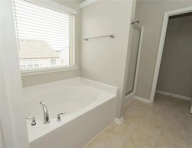 a bathroom with bathtub and window