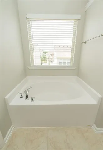a view of a chair and table in backyard of the house