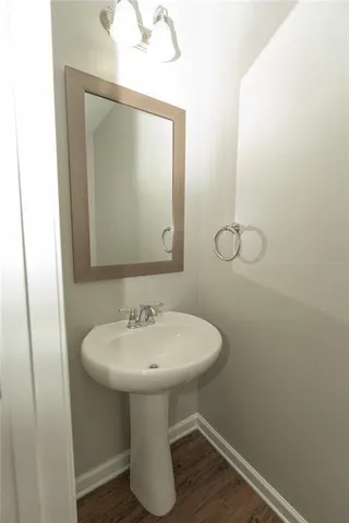 a bathroom with a sink toilet and mirror