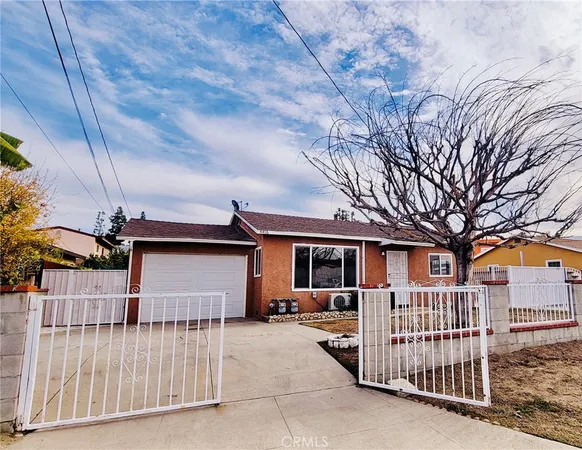 a view of a house with a wooden fence
