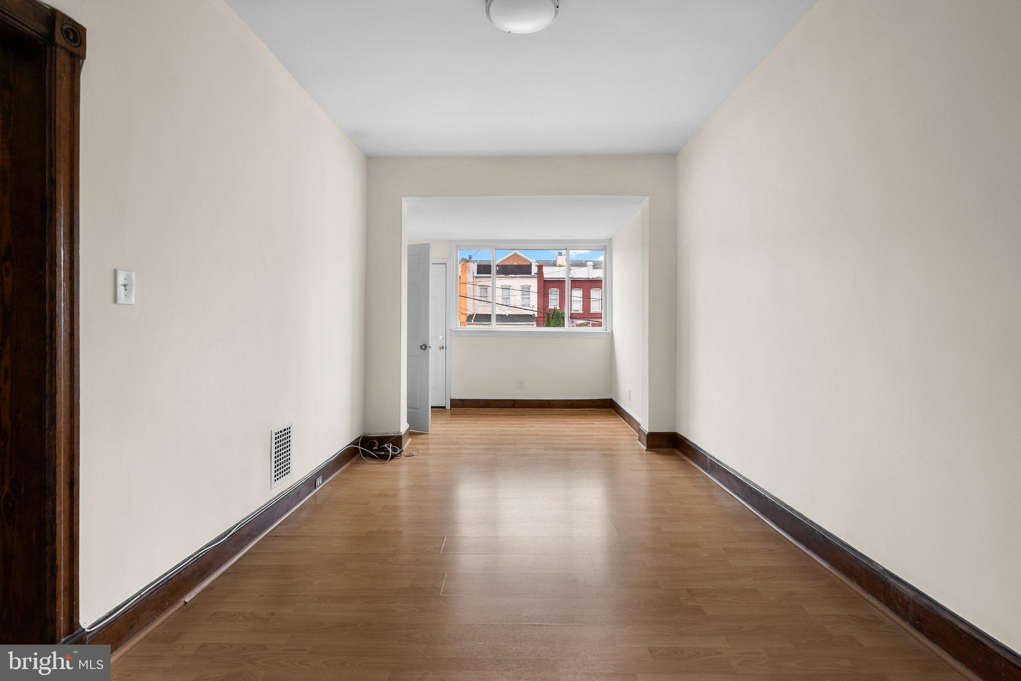 121 U Street Northeast Washington, DC 20002 - Photo 5 of 31 an empty room with wooden floor and windows
