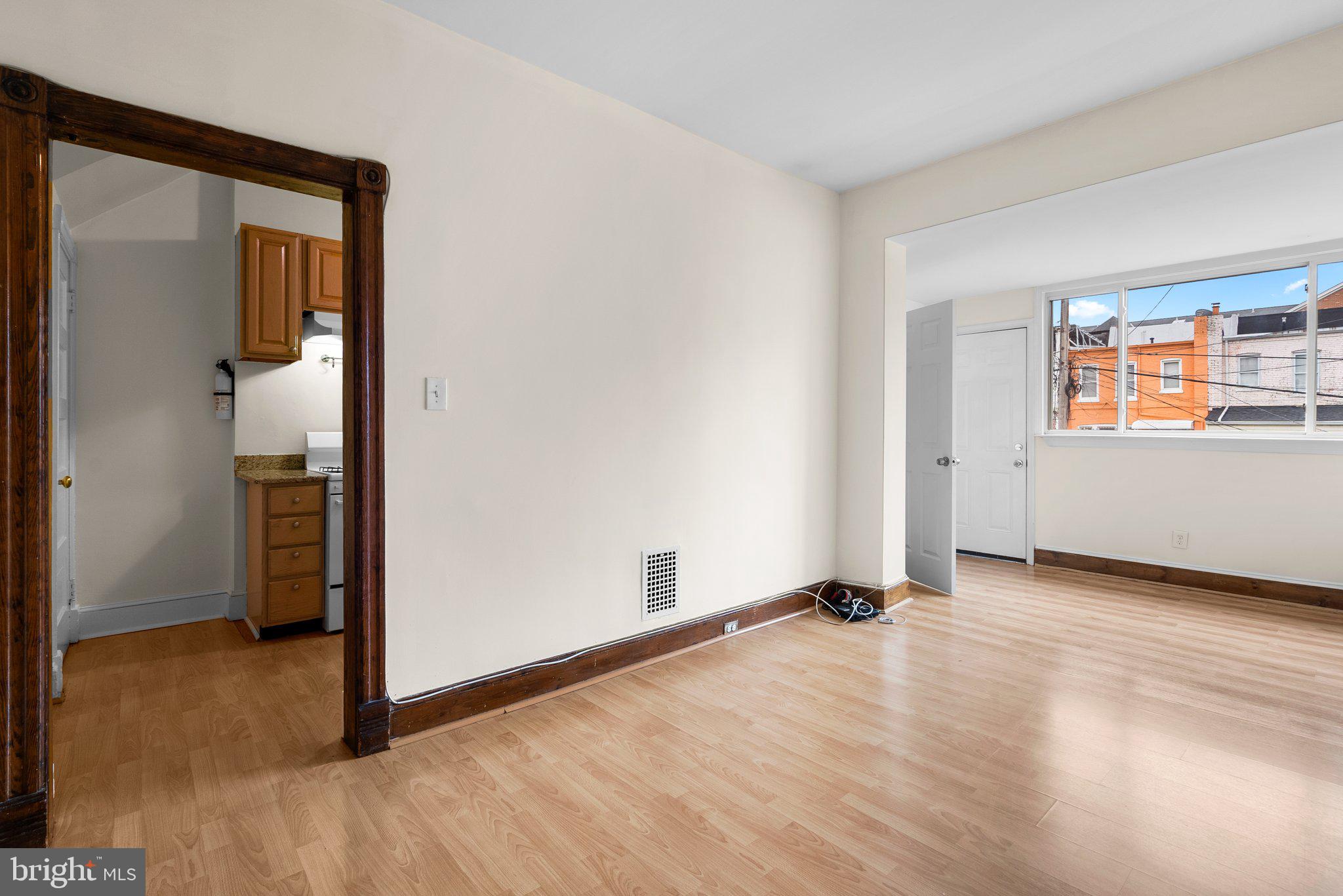 121 U Street Northeast Washington, DC 20002 - Photo 6 of 31 an empty room with wooden floor and windows