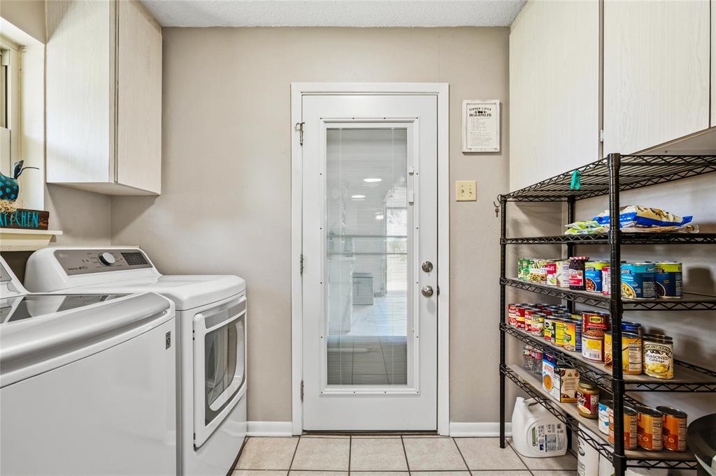 235 Magnus Road Denison, TX 75021 - Photo 25 of 35 a view of storage and utility room with washer and dryer