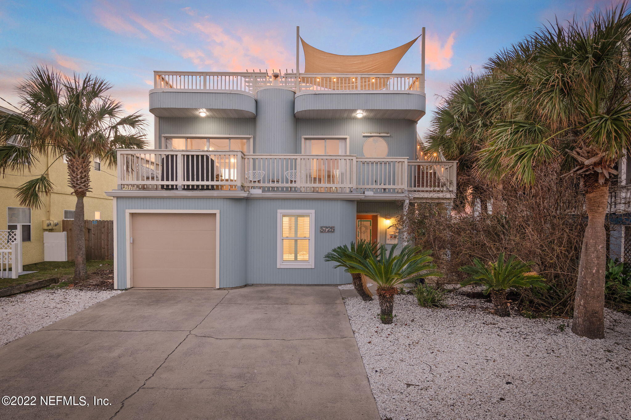 a view of a house with a tub and potted plants