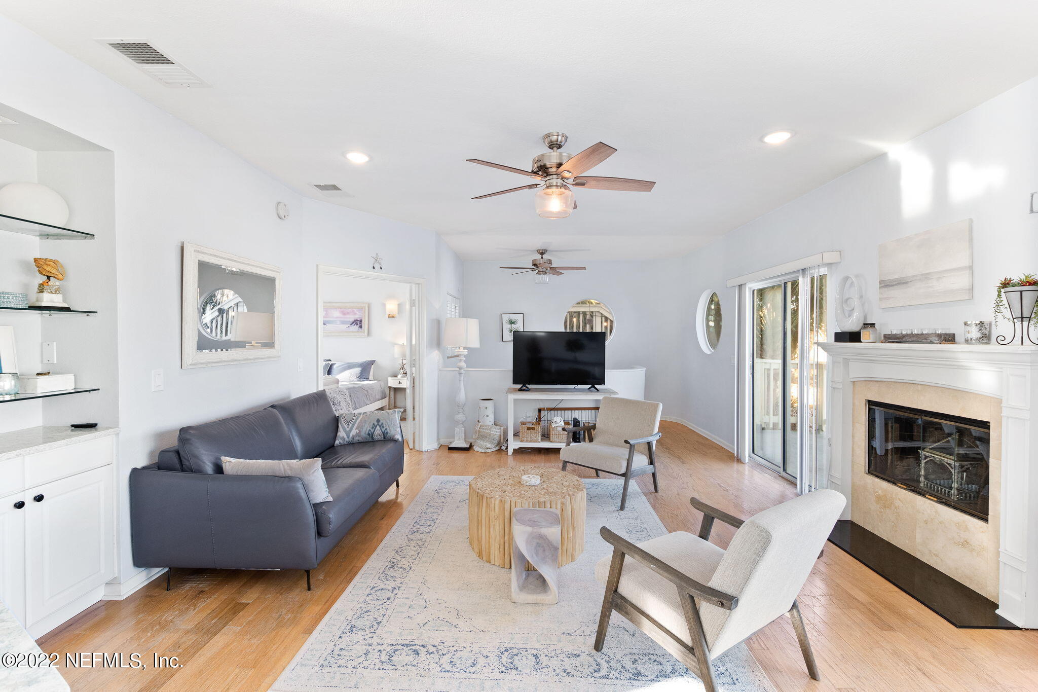 5725 Rudolph Avenue St. Augustine, FL 32080 - Photo 12 of 94 a living room with furniture a fireplace and a flat screen tv