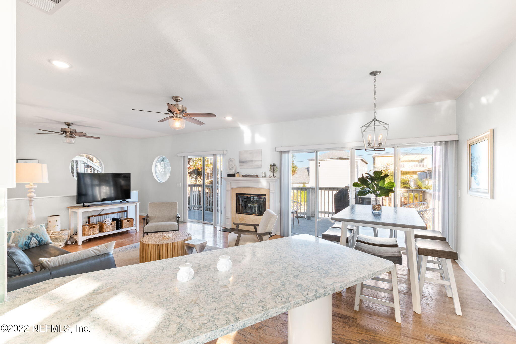 5725 Rudolph Avenue St. Augustine, FL 32080 - Photo 14 of 94 a living room with furniture a flat screen tv and a fireplace