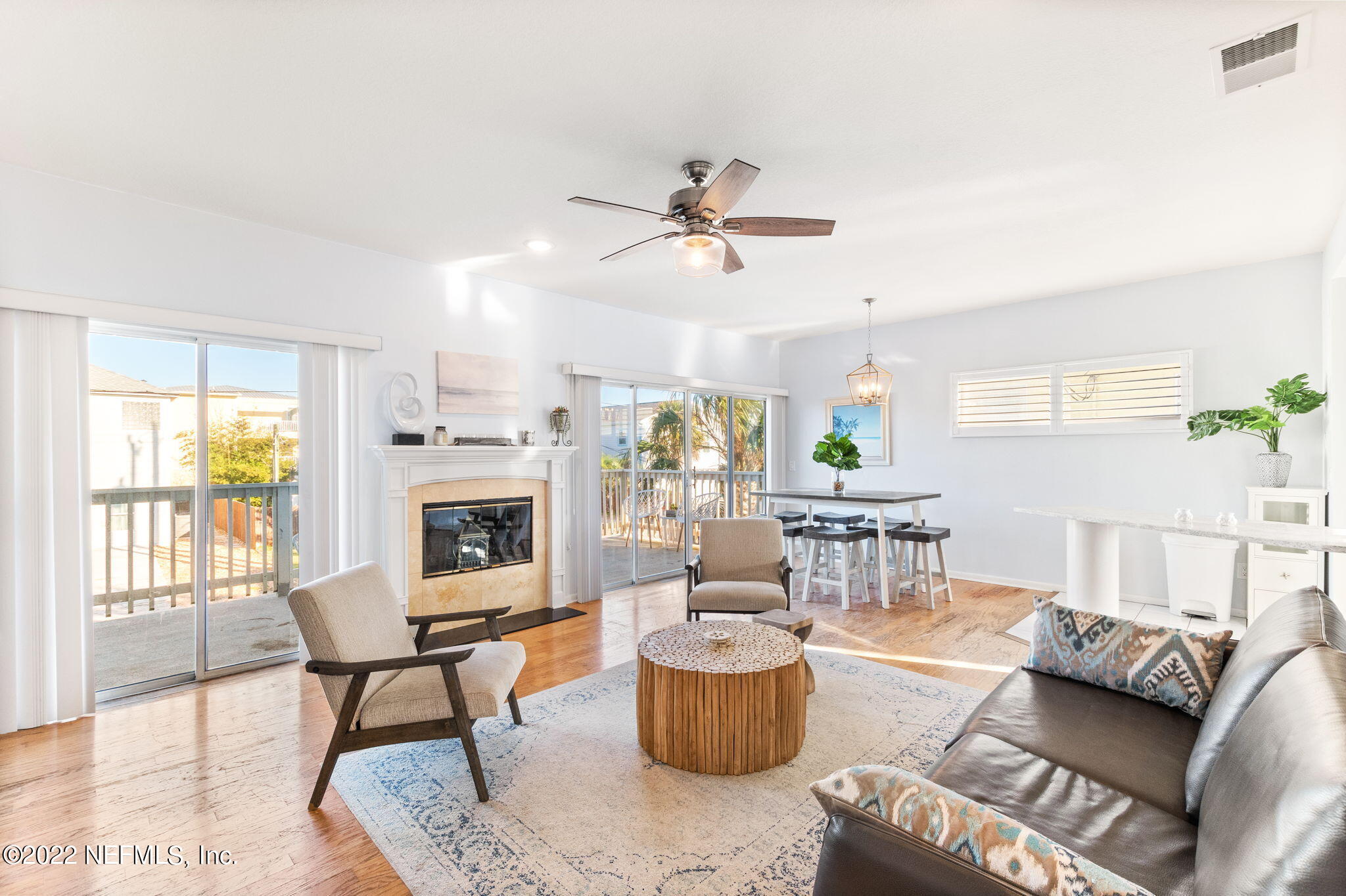 5725 Rudolph Avenue St. Augustine, FL 32080 - Photo 15 of 94 a living room with furniture a fireplace and a potted plant