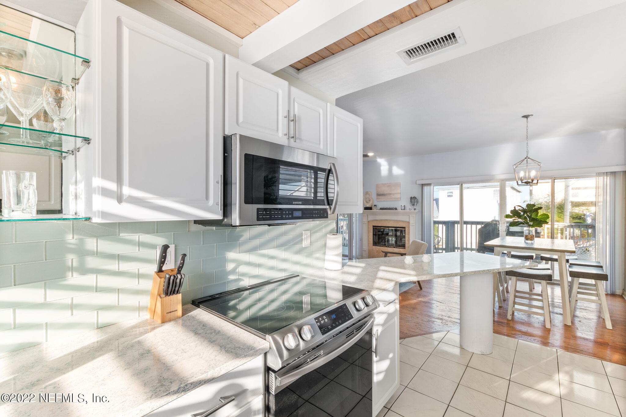 5725 Rudolph Avenue St. Augustine, FL 32080 - Photo 23 of 94 a kitchen with stainless steel appliances kitchen island granite countertop a stove and a sink