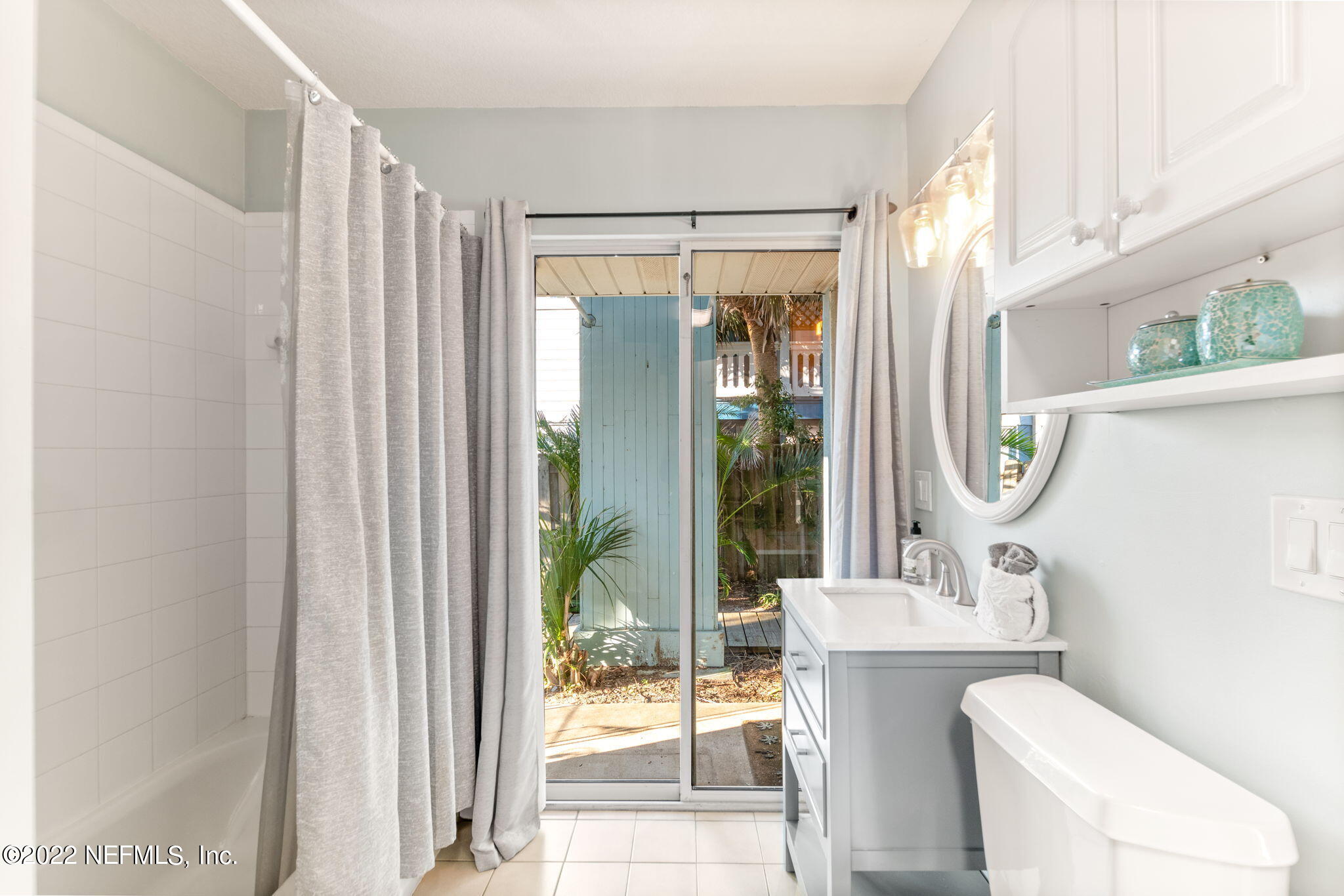 5725 Rudolph Avenue St. Augustine, FL 32080 - Photo 39 of 94 a bathroom with a toilet a sink and a mirror