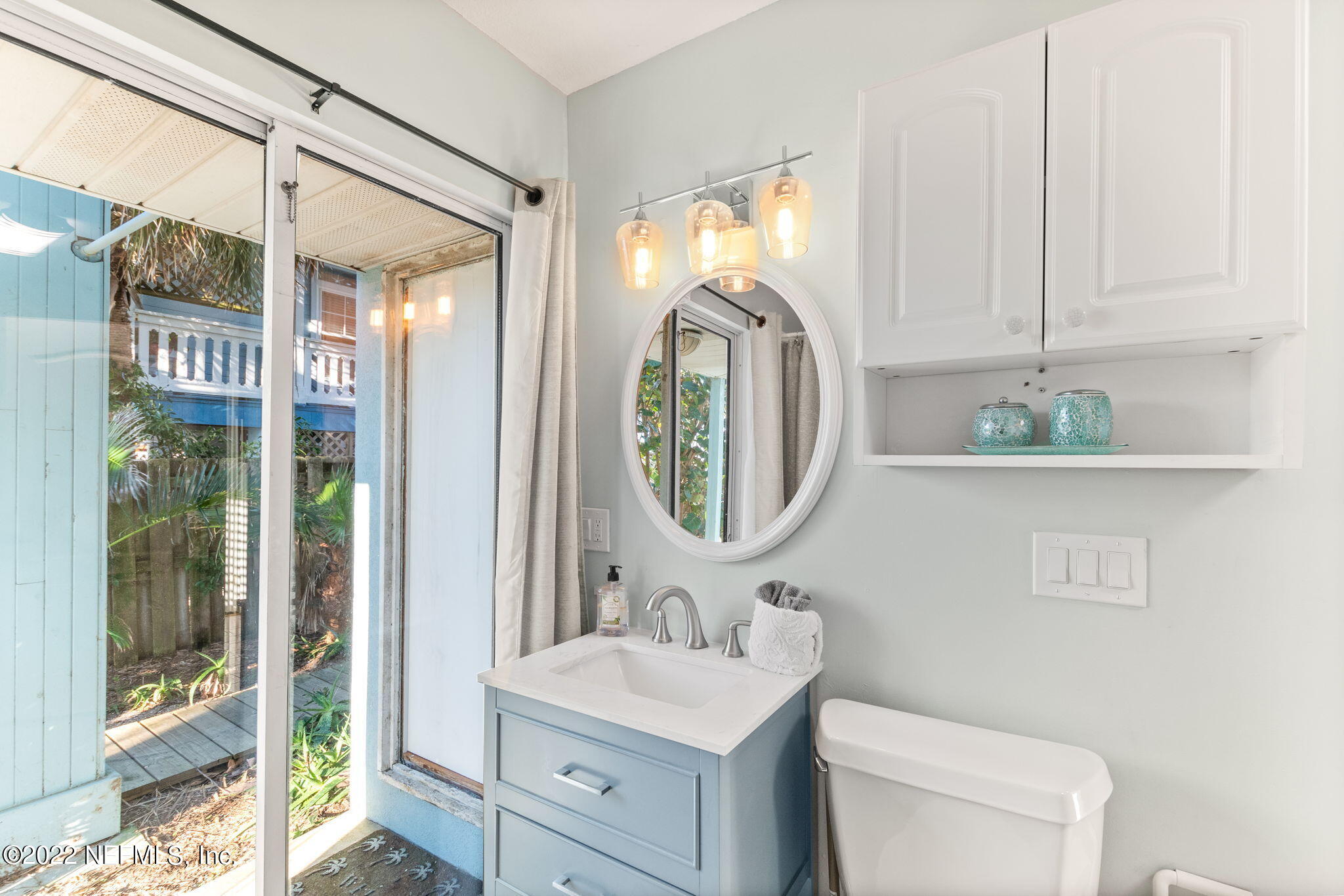 5725 Rudolph Avenue St. Augustine, FL 32080 - Photo 40 of 94 a bathroom with a toilet a sink and a mirror