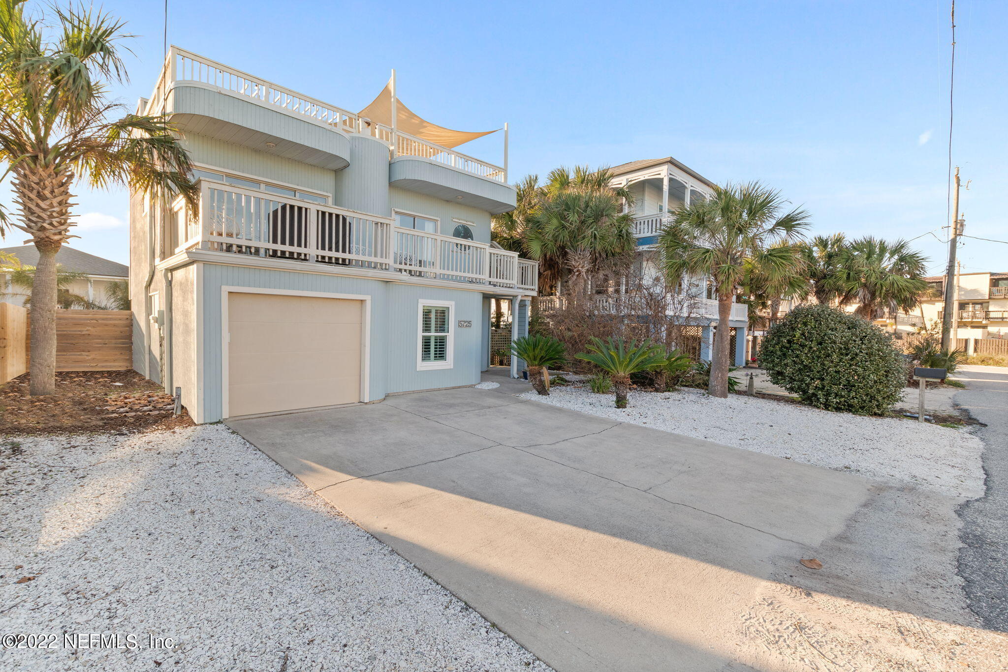 5725 Rudolph Avenue St. Augustine, FL 32080 - Photo 4 of 94 a view of a house with a yard and palm trees