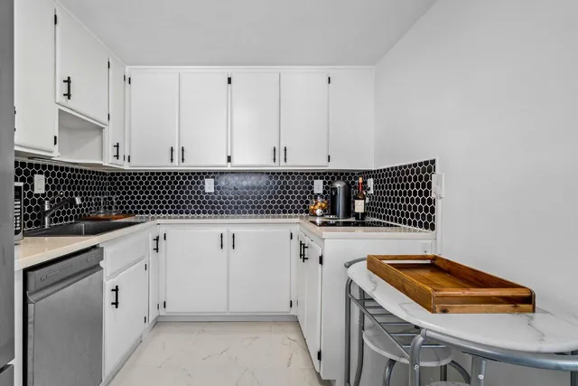 a view of a refrigerator in kitchen and windows
