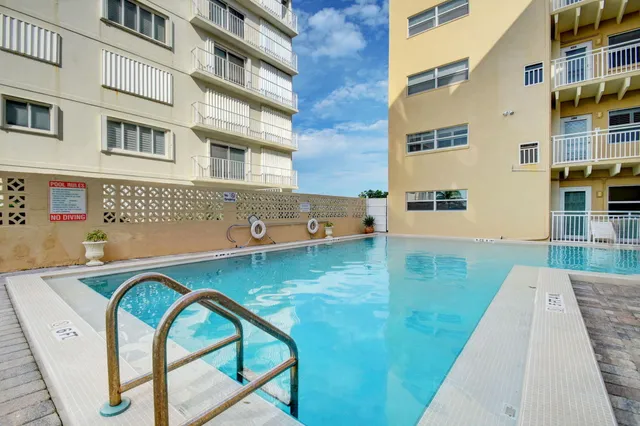 a view of swimming pool with outdoor seating