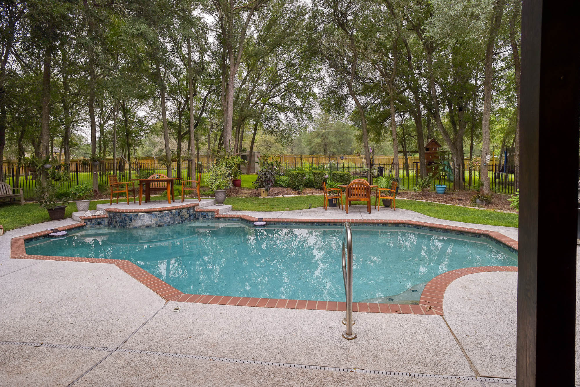 147 Spring Meadow Road Bastrop, TX 78602 - Photo 30 of 40 In-ground swimming pool with a brick coping and concrete deck