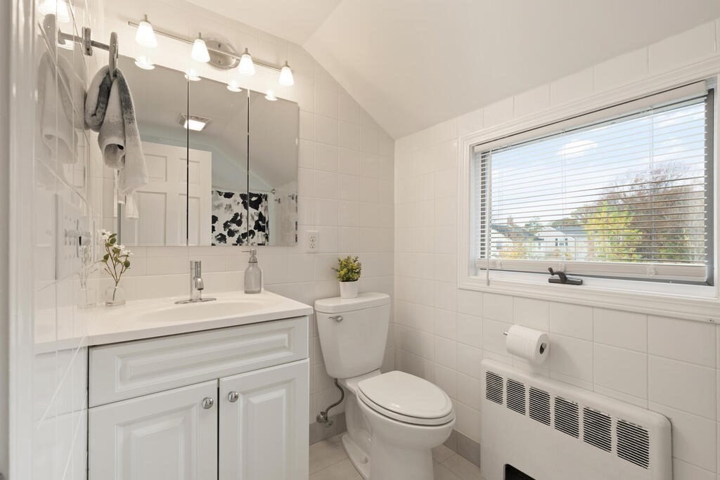 39 Nathaniel Road Winchester, MA 01890 - Photo 20 of 38 a bathroom with a sink a toilet and a large mirror