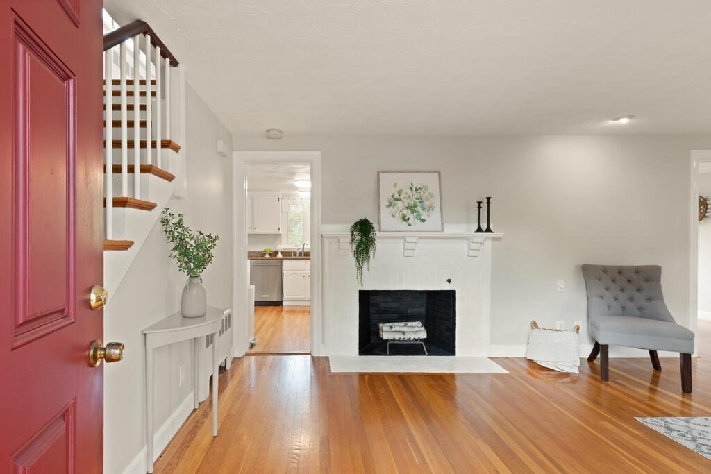 39 Nathaniel Road Winchester, MA 01890 - Photo 25 of 38 a view of a livingroom with wooden floor and a fireplace