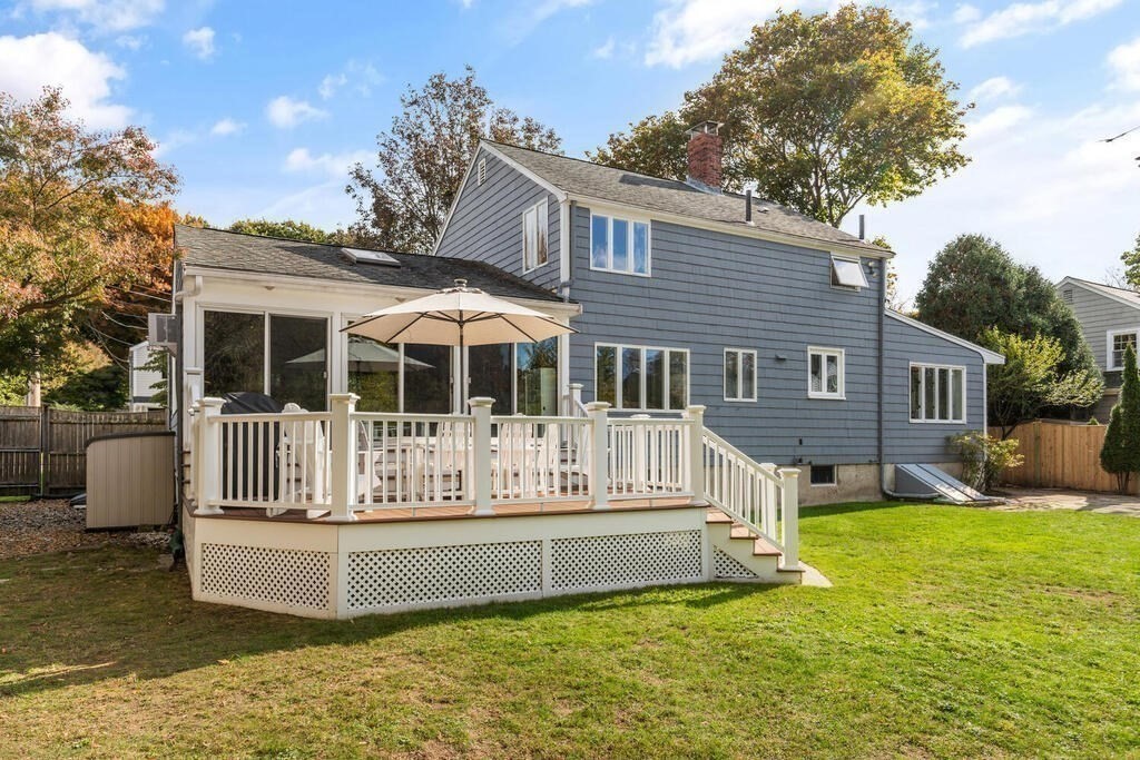 39 Nathaniel Road Winchester, MA 01890 - Photo 28 of 38 a white house that has a small yard plants and large trees with wooden fence
