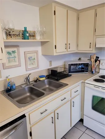 a kitchen with white cabinets and white appliances