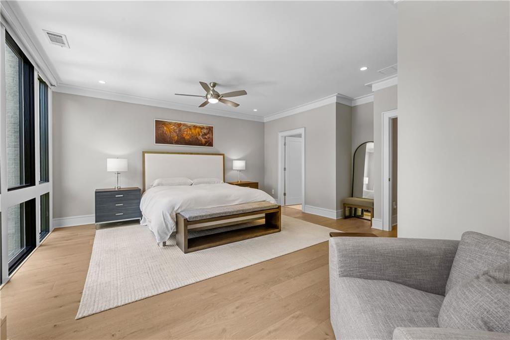 1272 Appleden Way, Unit 19 Atlanta, GA 30319 - Photo 13 of 26 a bedroom with a bed a couch and a chandelier