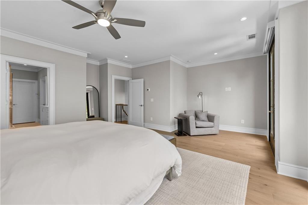 1272 Appleden Way, Unit 19 Atlanta, GA 30319 - Photo 14 of 26 a spacious bedroom with a bed and ceiling fan
