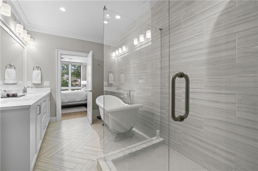 1272 Appleden Way, Unit 19 Atlanta, GA 30319 - Photo 15 of 26 a bathroom with a sink a toilet a rug and shower