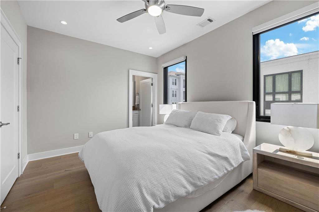 1272 Appleden Way, Unit 19 Atlanta, GA 30319 - Photo 17 of 26 a bedroom with a bed and a chandelier