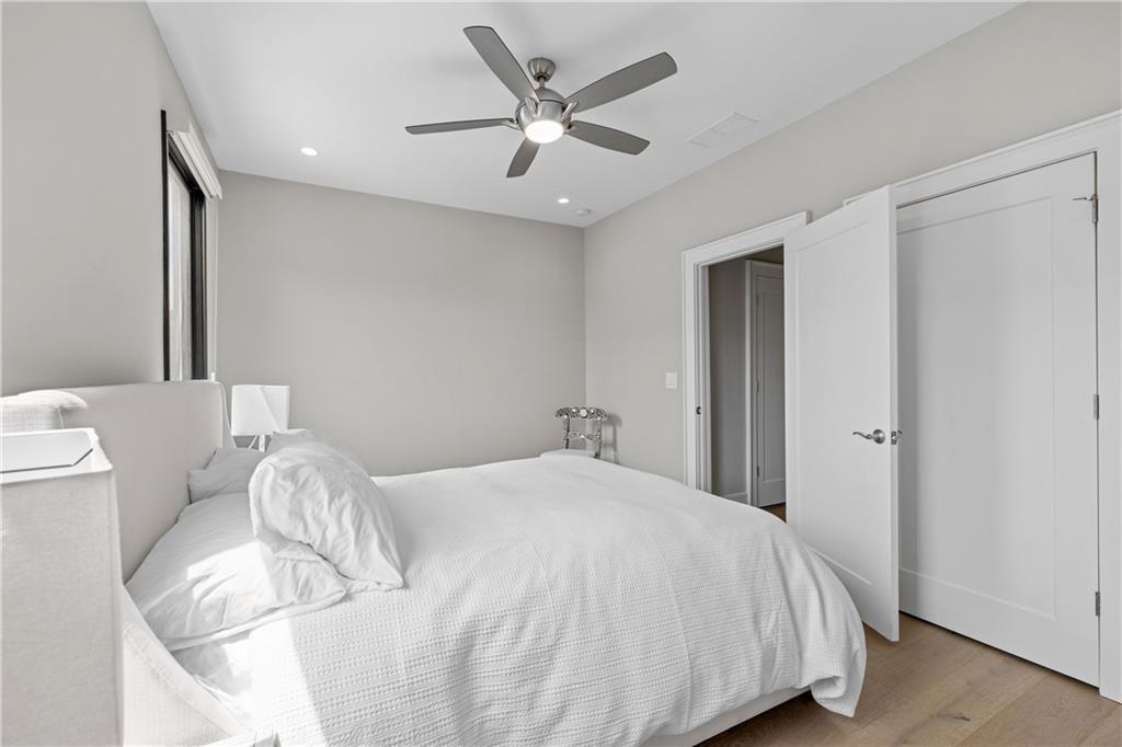 1272 Appleden Way, Unit 19 Atlanta, GA 30319 - Photo 18 of 26 a bedroom with a bed and a ceiling fan