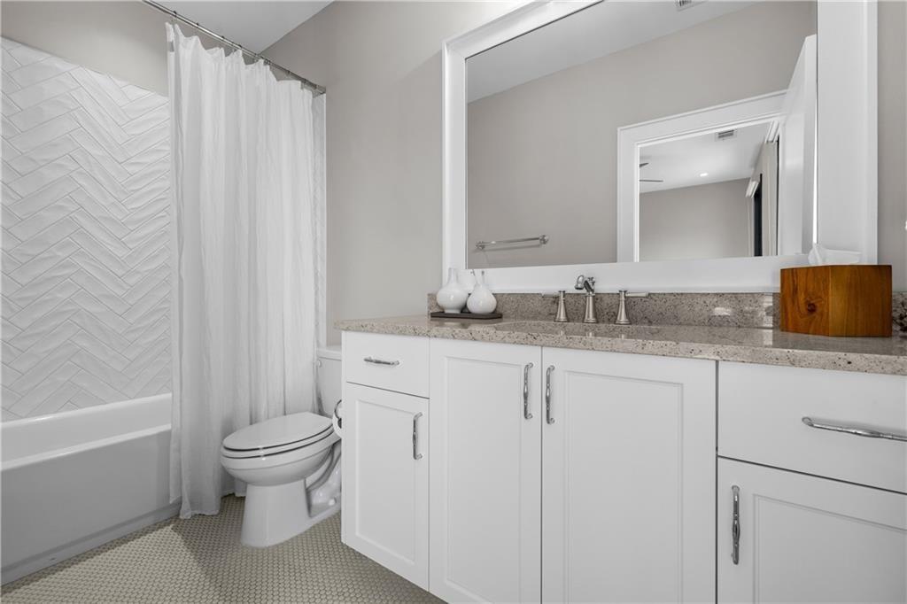 1272 Appleden Way, Unit 19 Atlanta, GA 30319 - Photo 19 of 26 a bathroom with a granite countertop sink toilet and shower