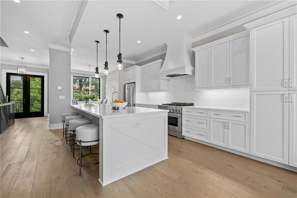 1272 Appleden Way, Unit 19 Atlanta, GA 30319 - Photo 2 of 26 a kitchen with white cabinets and stainless steel appliances