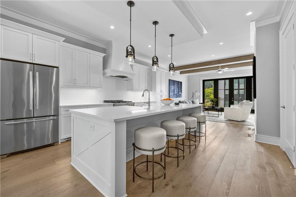1272 Appleden Way, Unit 19 Atlanta, GA 30319 - Photo 3 of 26 a kitchen with stainless steel appliances granite countertop a refrigerator a sink dishwasher a oven and a dining table with wooden floor
