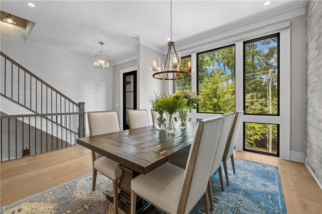 1272 Appleden Way, Unit 19 Atlanta, GA 30319 - Photo 9 of 26 a view of a dining room with furniture window and wooden floor