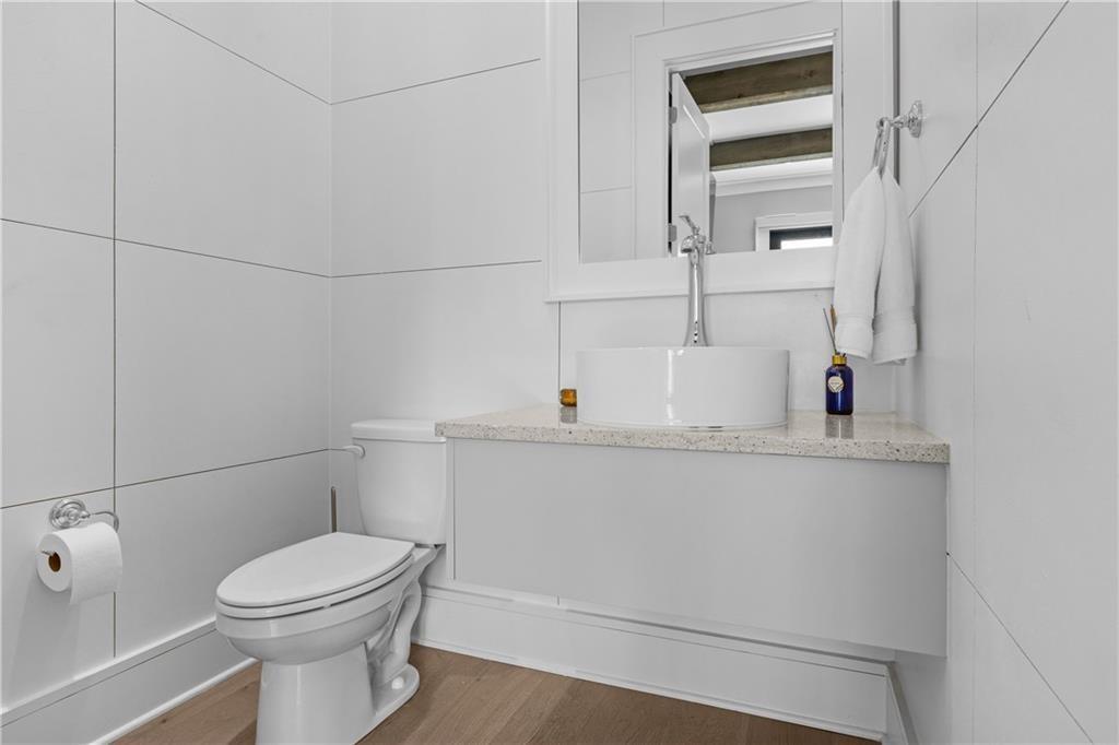 1272 Appleden Way, Unit 19 Atlanta, GA 30319 - Photo 10 of 26 a bathroom with a sink a toilet and mirror