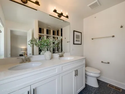 a bathroom with a granite countertop sink a shower and a mirror