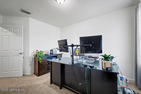 a dining room with furniture and potted plant