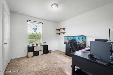 a bedroom with furniture and a window