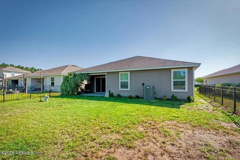 a view of a house with a yard and garden