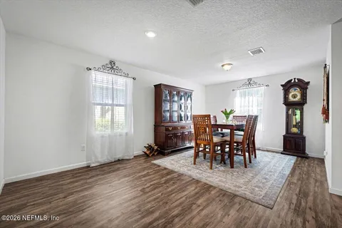a view of a dining room with furniture and window